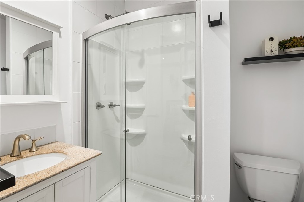 736 Griffith Place Laguna Beach, CA 92651 - Photo 23 of 24 a bathroom with a granite countertop sink toilet and shower
