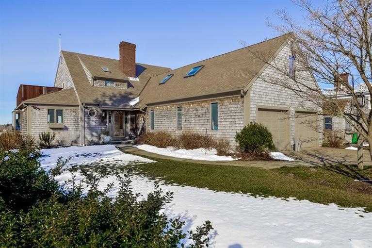 46 Gibson Road Orleans, MA 02653 - Photo 21 of 22 a front view of a house with a garden and patio