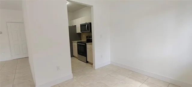a kitchen with granite countertop a sink and a stove top oven
