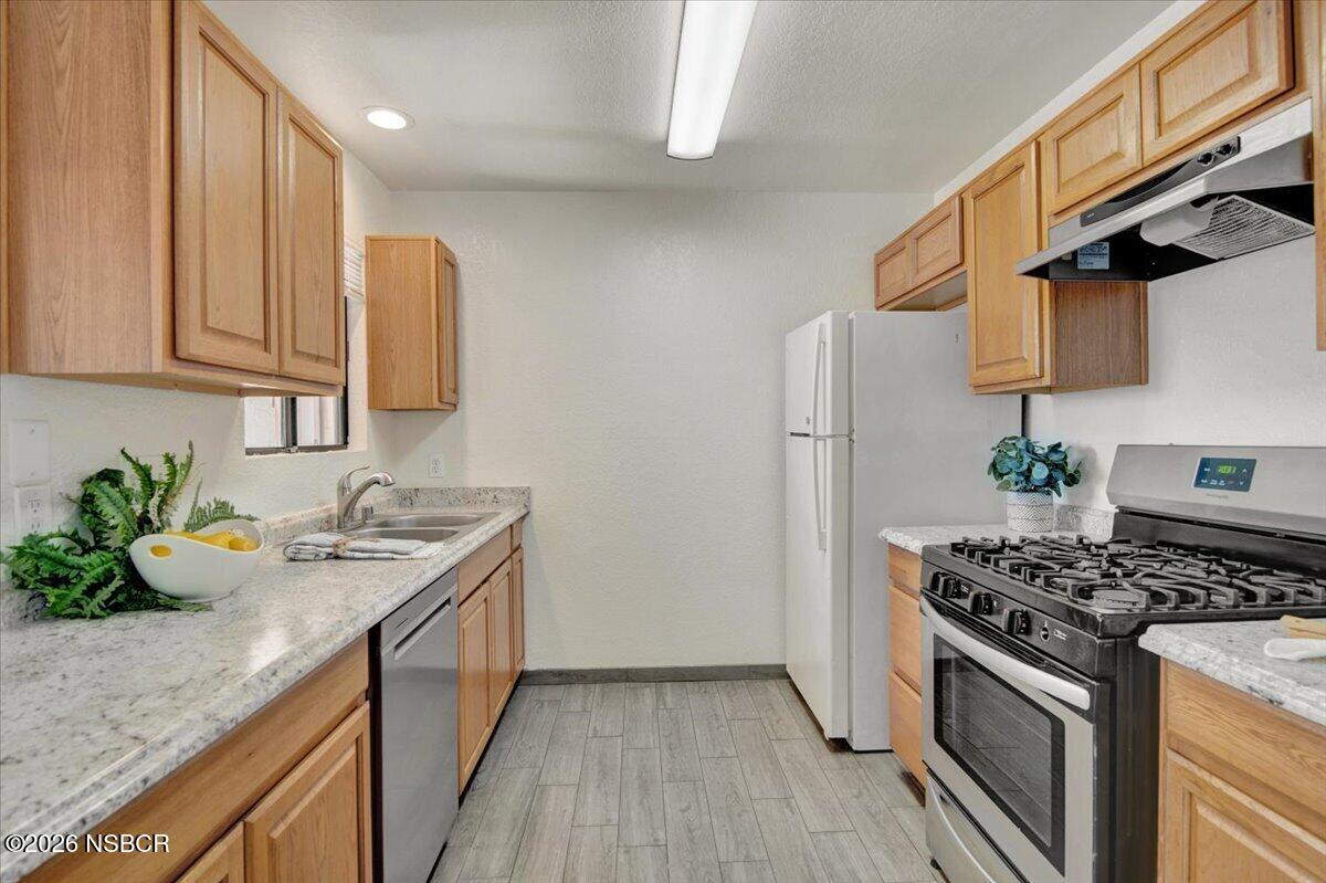 3400 Santa Maria Way, Unit 207B Santa Maria, CA 93455 - Photo 24 of 50 a kitchen with stainless steel appliances granite countertop a sink stove and refrigerator