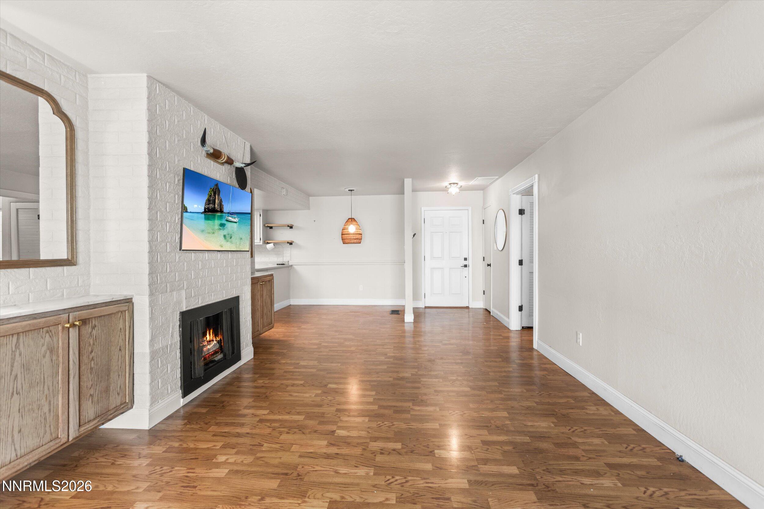 2300 Dickerson Road, Unit 51 Reno, NV 89503 - Photo 13 of 46 a view of a livingroom with wooden floor and a fireplace