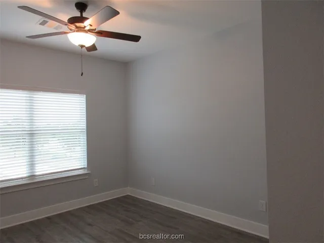 a room with a window and a fan