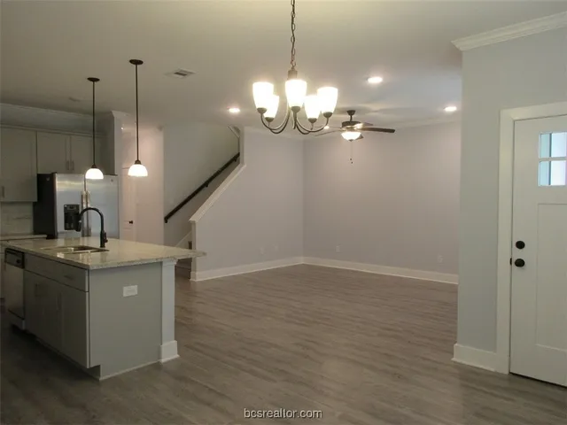 a view of a kitchen with a sink and chandelier