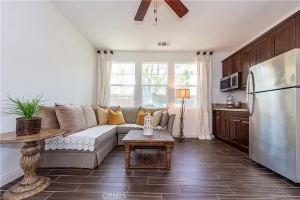 a living room with furniture fireplace and wooden floor