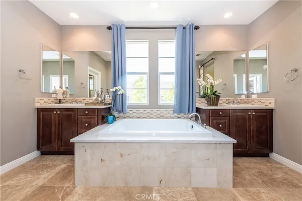 a spacious bathroom with a sink double vanity and a mirror
