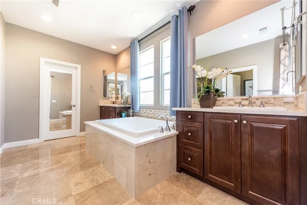 a spacious bathroom with a sink a mirror and a shower
