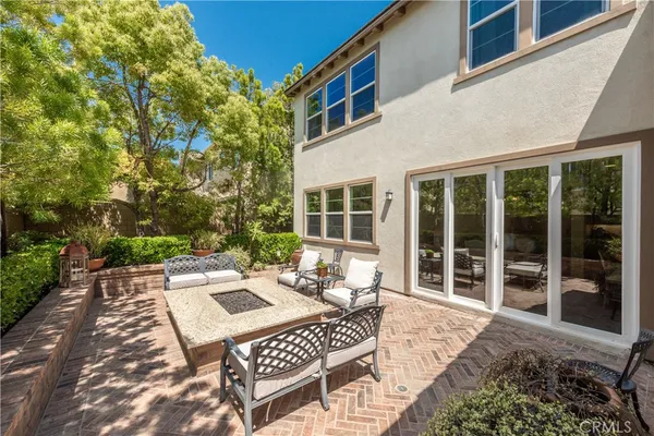 a view of a patio with table and chairs with wooden floor and fence