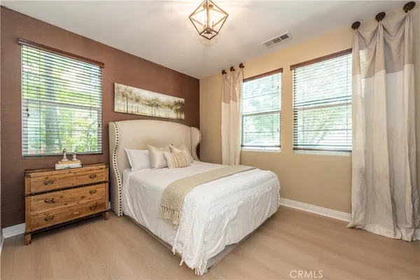 a bedroom with a bed closet and window