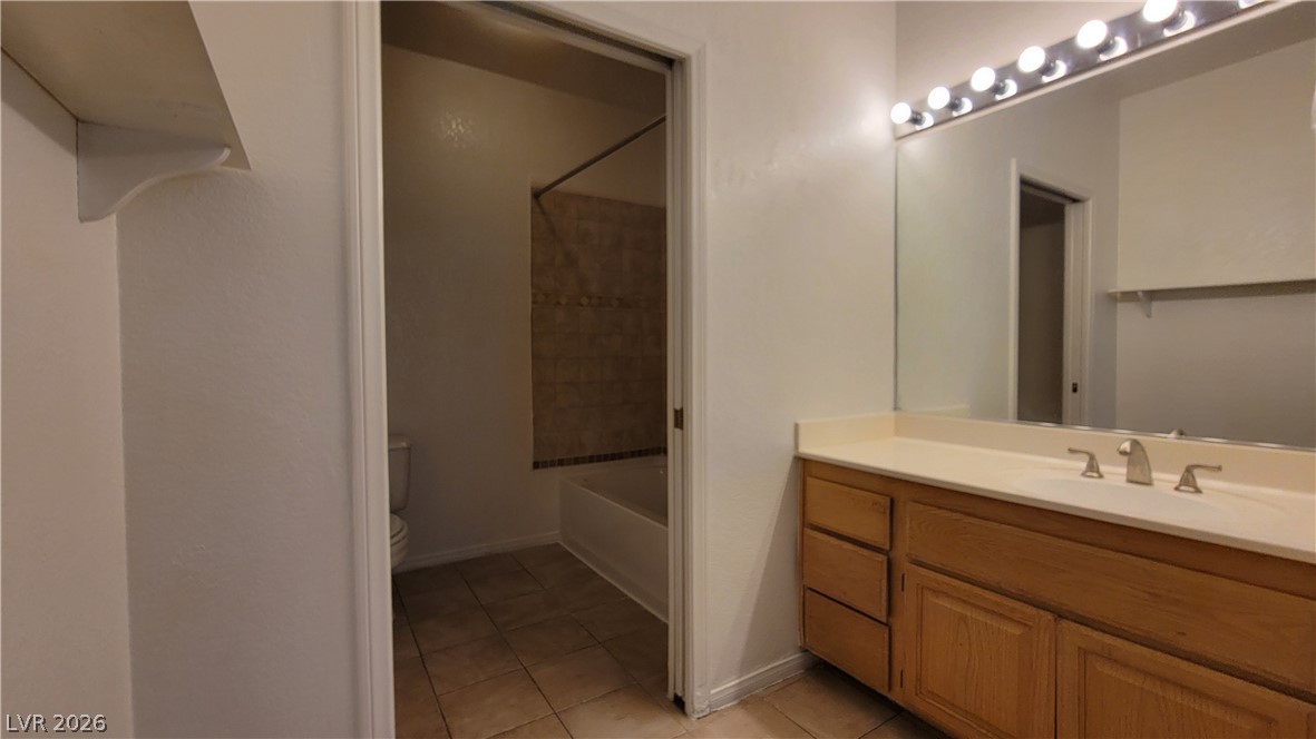 3320 South Fort Apache Road, Unit 111 Las Vegas, NV 89117 - Photo 6 of 12 A well-appointed bathroom offers a vanity with ample storage and a bright, functional mirror.