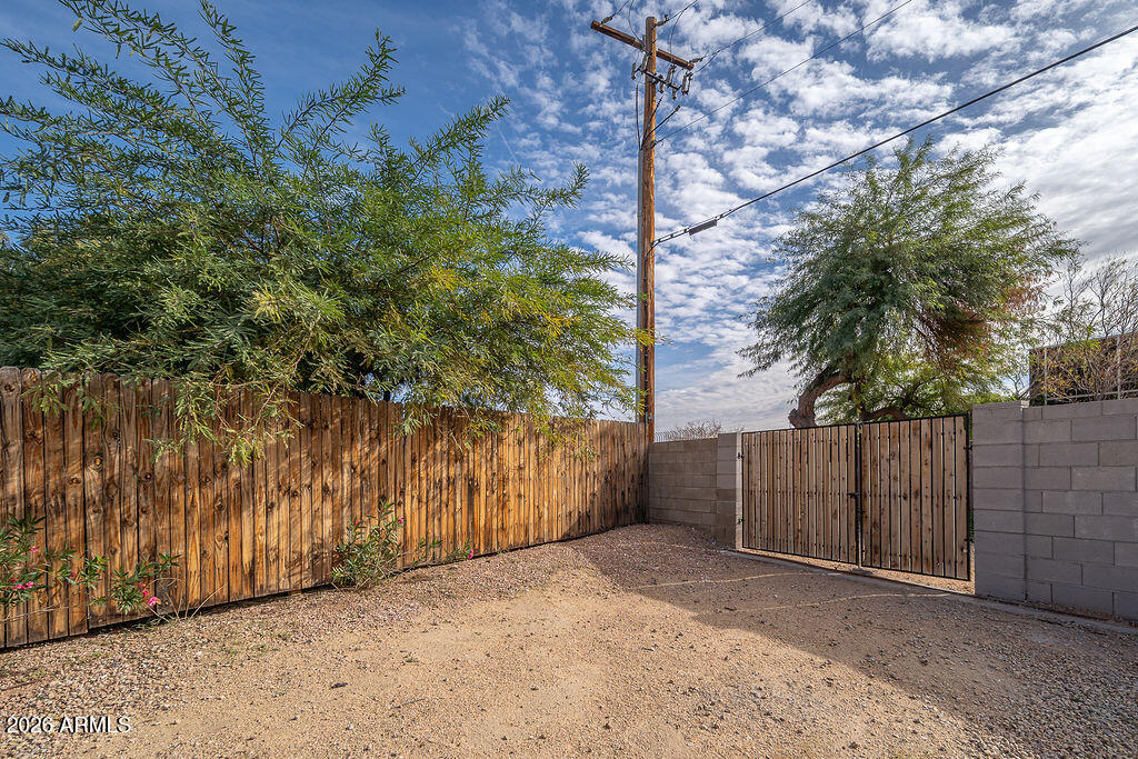 4653 East Almeria Road Phoenix, AZ 85008 - Photo 15 of 18 a view of backyard with wooden fence