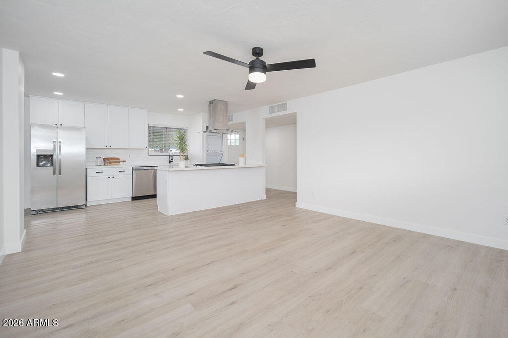 4653 East Almeria Road Phoenix, AZ 85008 - Photo 4 of 18 a view of a kitchen with a sink and a refrigerator