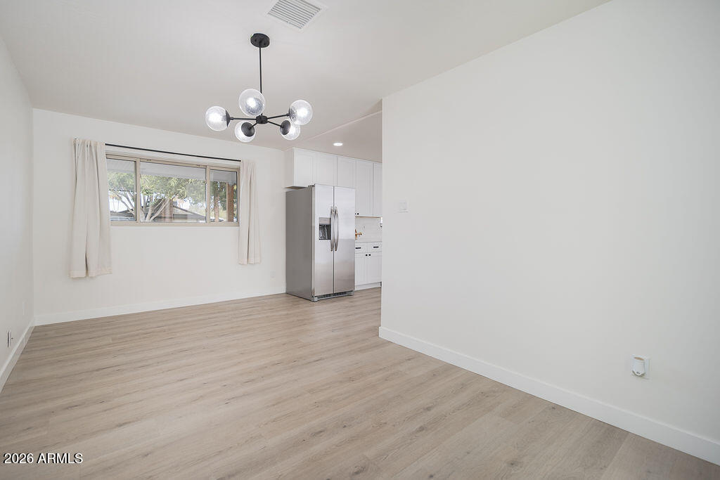 4653 East Almeria Road Phoenix, AZ 85008 - Photo 9 of 18 wooden floor in an empty room with a window