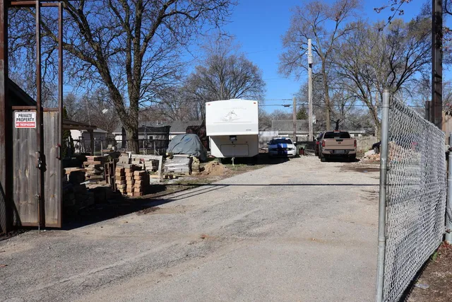 a view of a street with a large tree