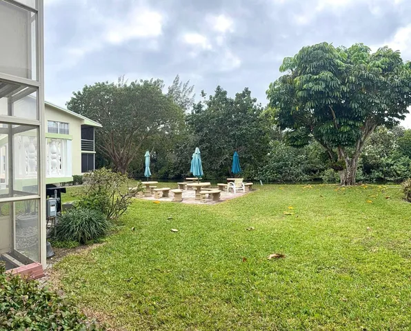 a swimming pool with outdoor seating and yard