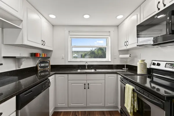 a kitchen with stainless steel appliances granite countertop a stove and a sink