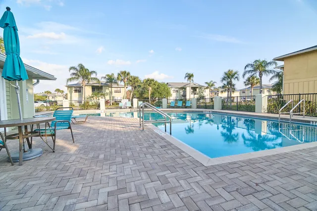 a view of a swimming pool with outdoor seating