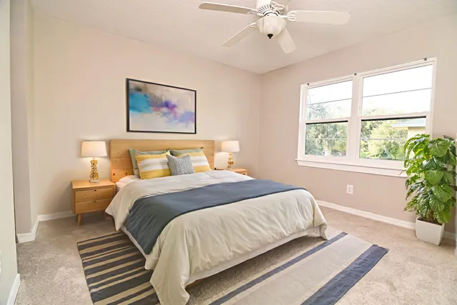 a bedroom with a large bed and a chandelier