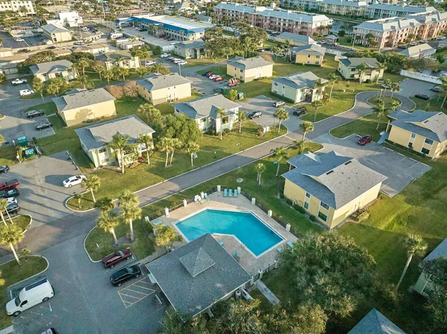 an aerial view of residential houses with outdoor space
