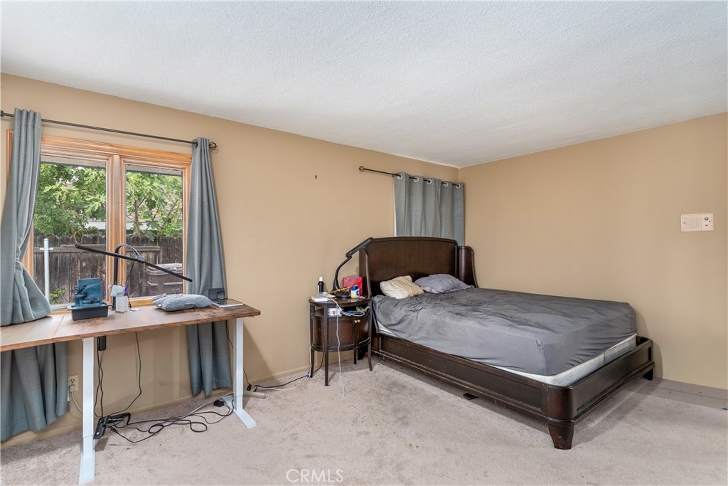 4967 Chapala Drive Riverside, CA 92507 - Photo 19 of 34 a bedroom with a bed and large windows