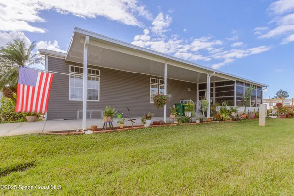 a view of a house with backyard porch and sitting area