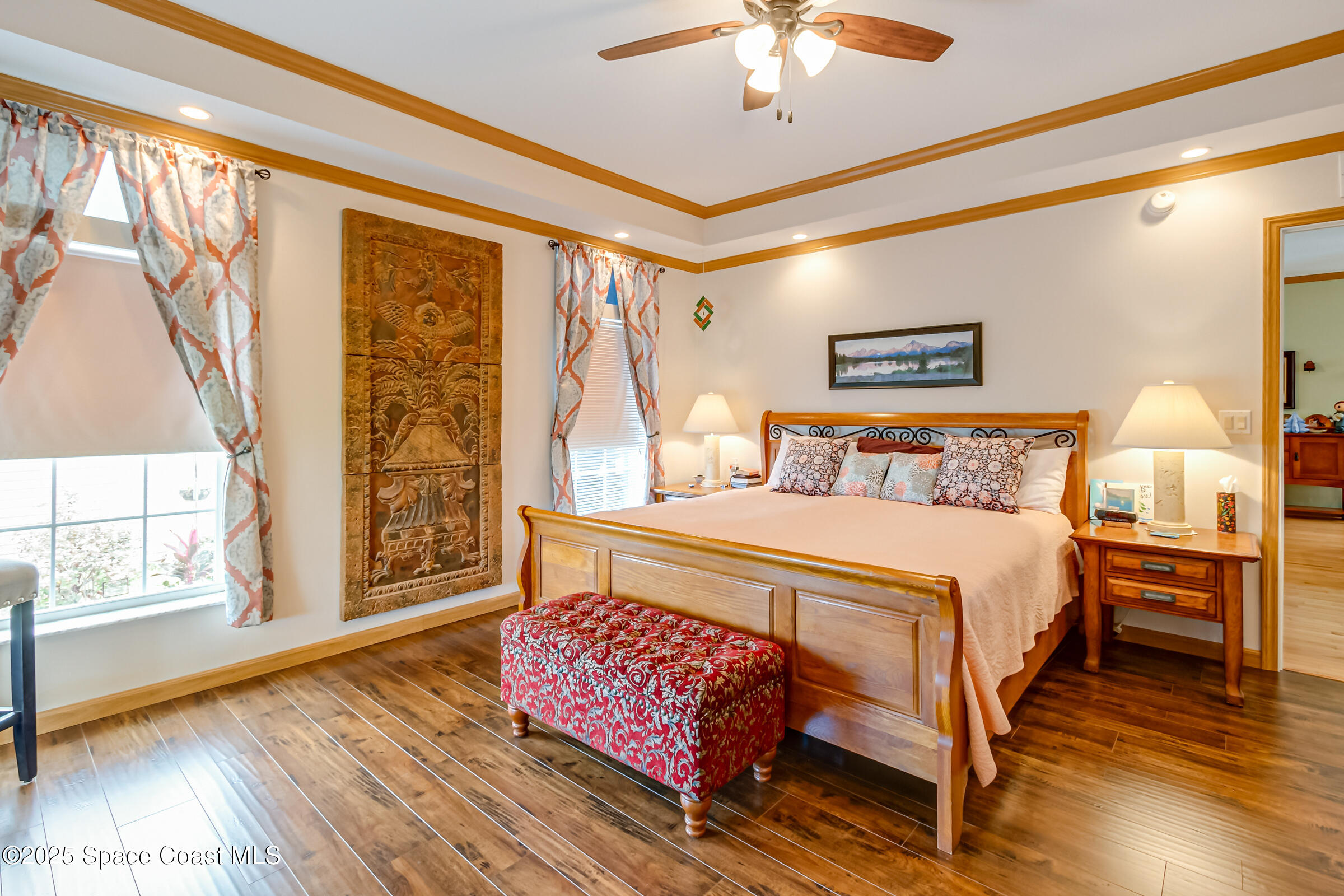 694 Outer Drive, Unit 184 Cocoa, FL 32926 - Photo 16 of 38 a bedroom with a bed and wooden floor