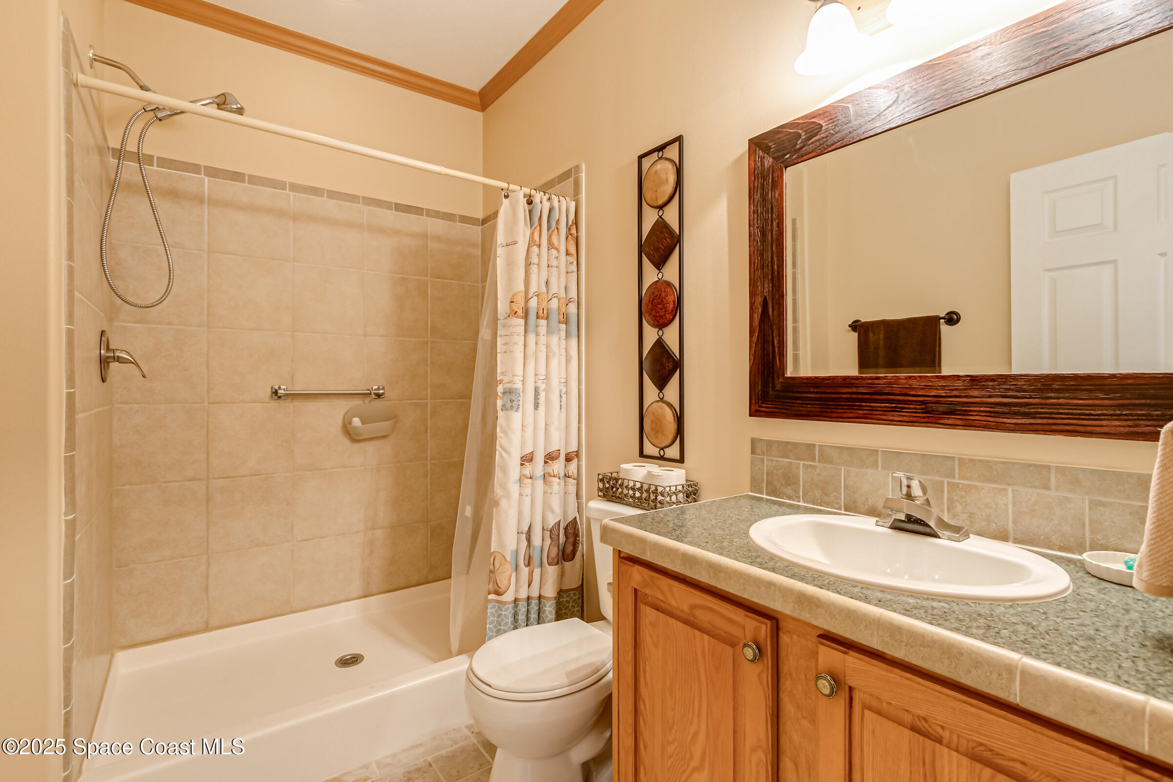 694 Outer Drive, Unit 184 Cocoa, FL 32926 - Photo 23 of 38 a bathroom with a granite countertop sink toilet and shower