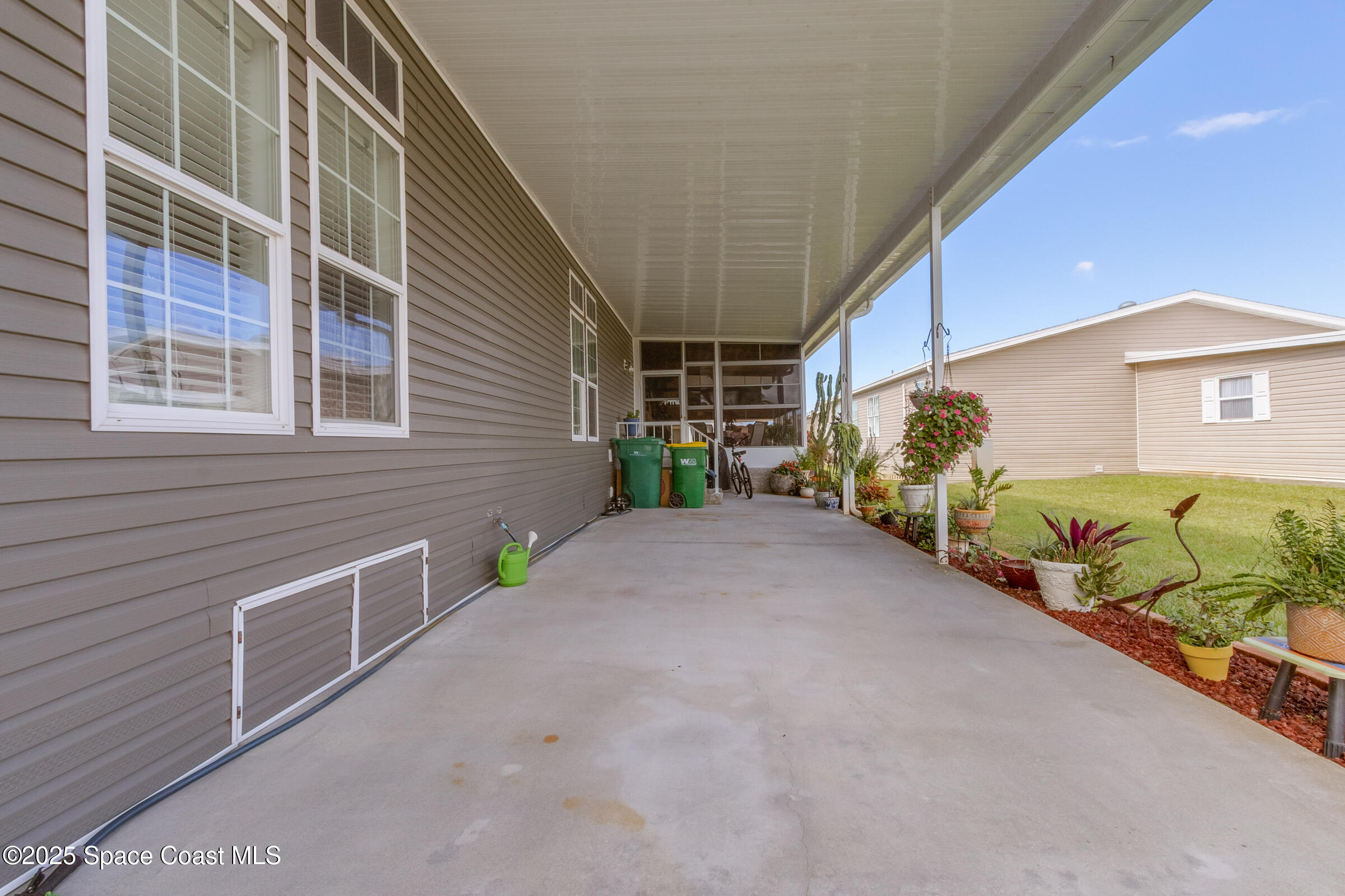 694 Outer Drive, Unit 184 Cocoa, FL 32926 - Photo 30 of 38 a view of a street with potted plants