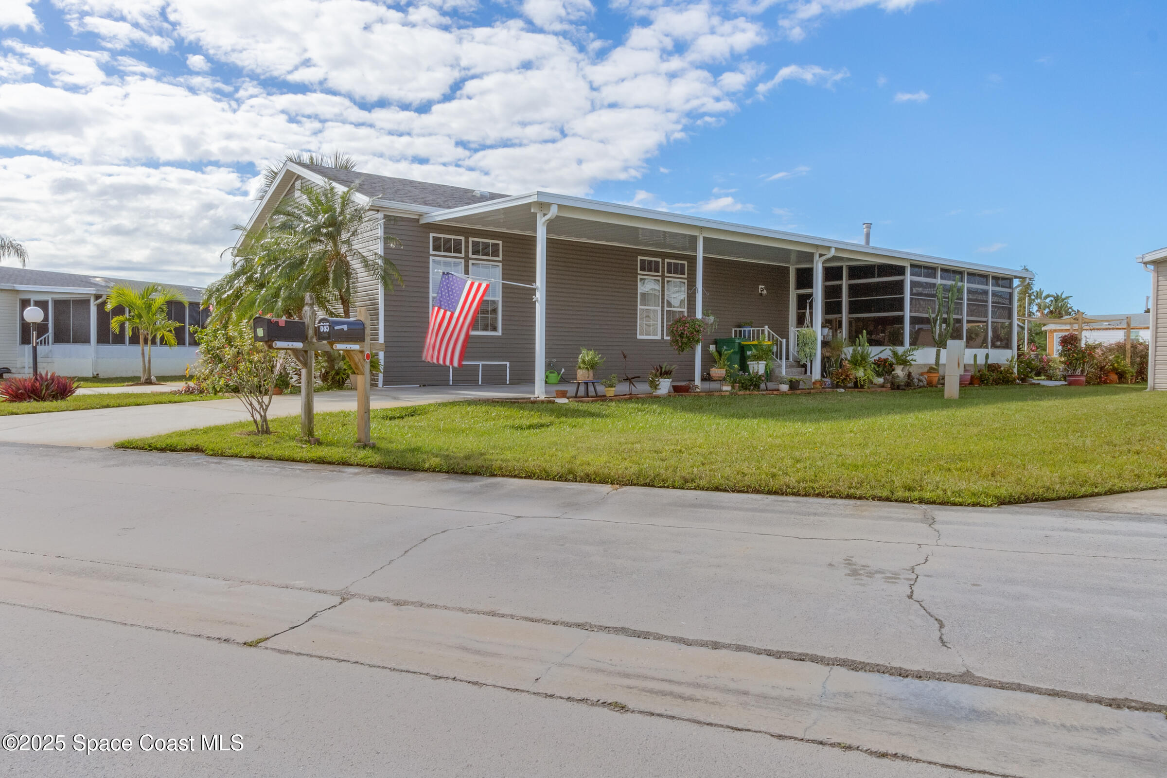 694 Outer Drive, Unit 184 Cocoa, FL 32926 - Photo 3 of 38 a view of a house with garden and trees