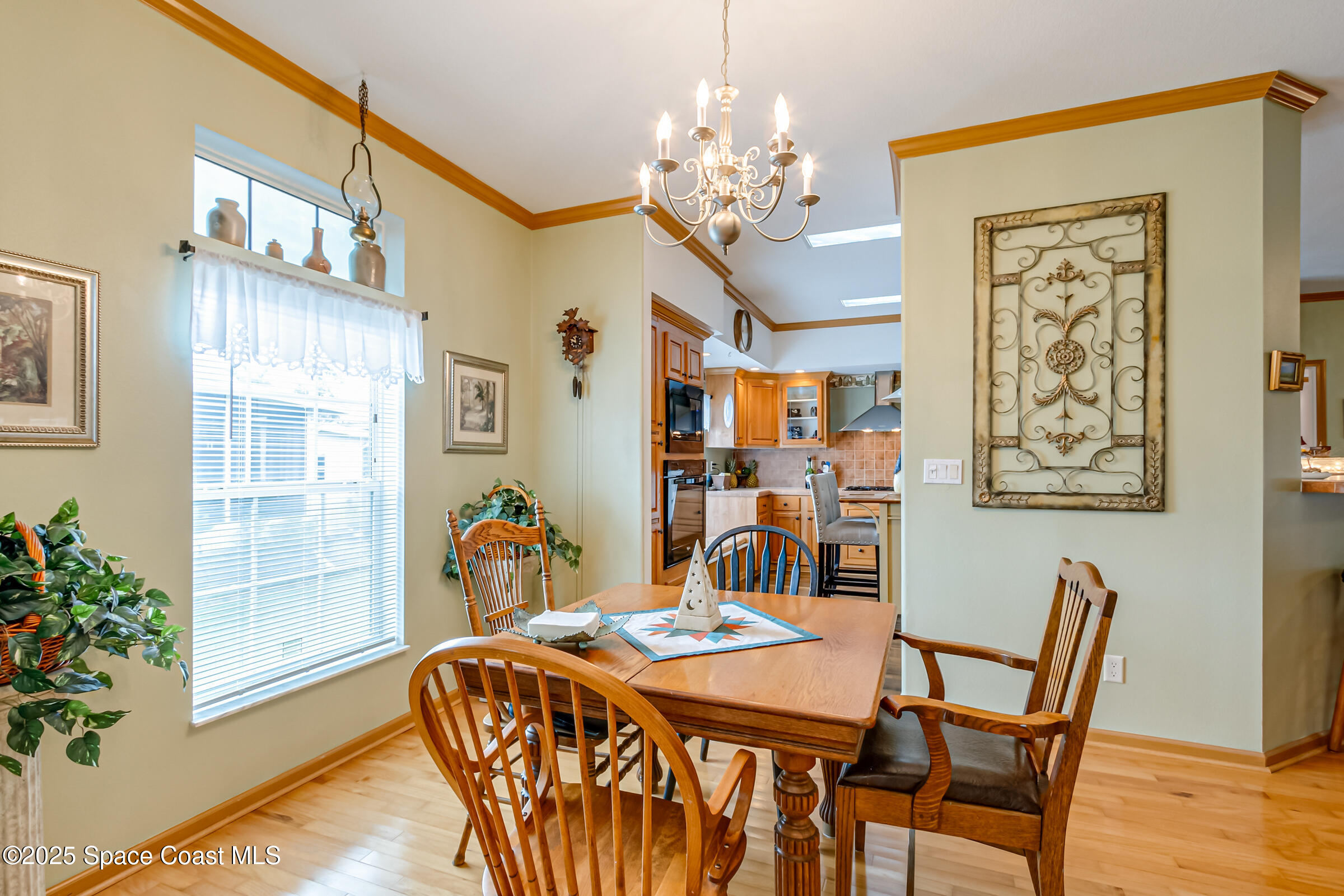 694 Outer Drive, Unit 184 Cocoa, FL 32926 - Photo 36 of 38 a dining room with furniture potted plants and wooden floor