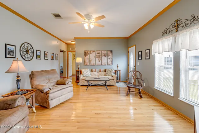 a living room with furniture and a clock