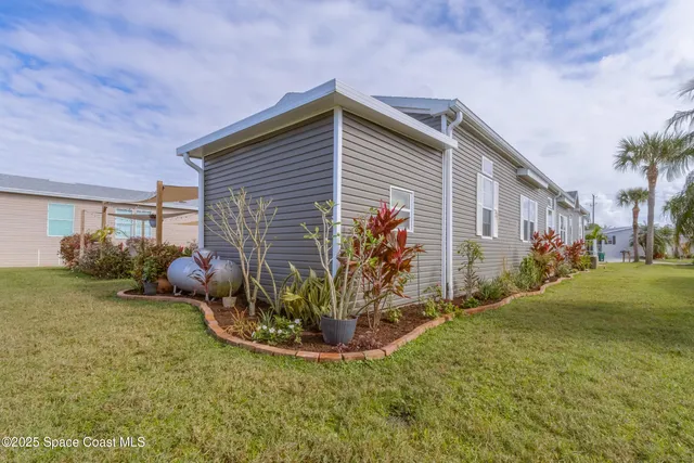 a view of a house with a yard and a garage