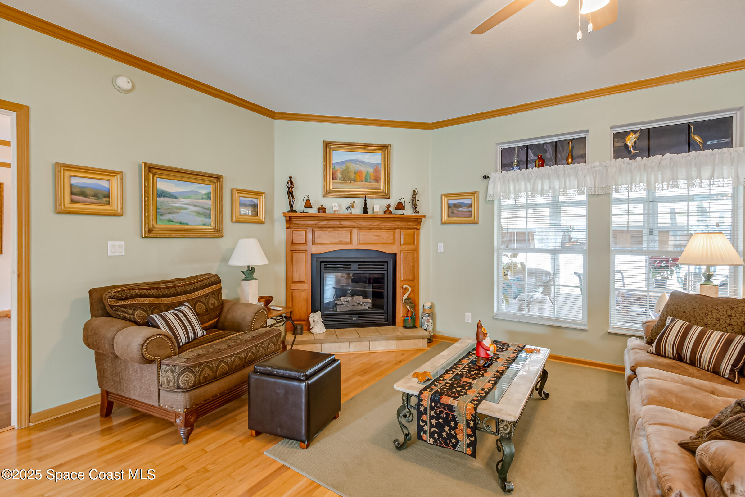 694 Outer Drive, Unit 184 Cocoa, FL 32926 - Photo 8 of 38 a living room with furniture large window and a fireplace