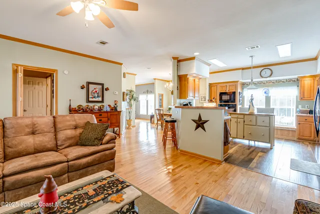 a living room with furniture and kitchen view