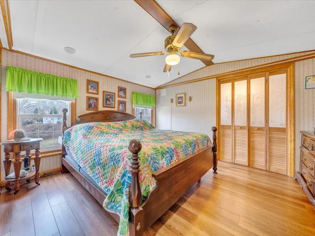 a bed sitting in a bedroom next to a window