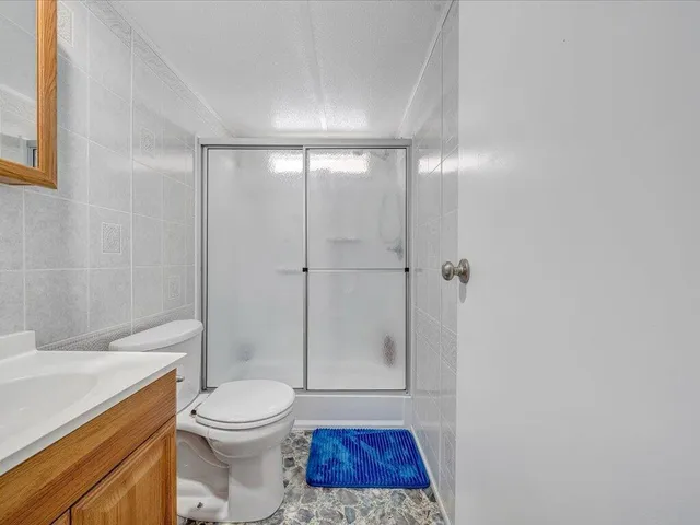 a bathroom with a toilet and a shower
