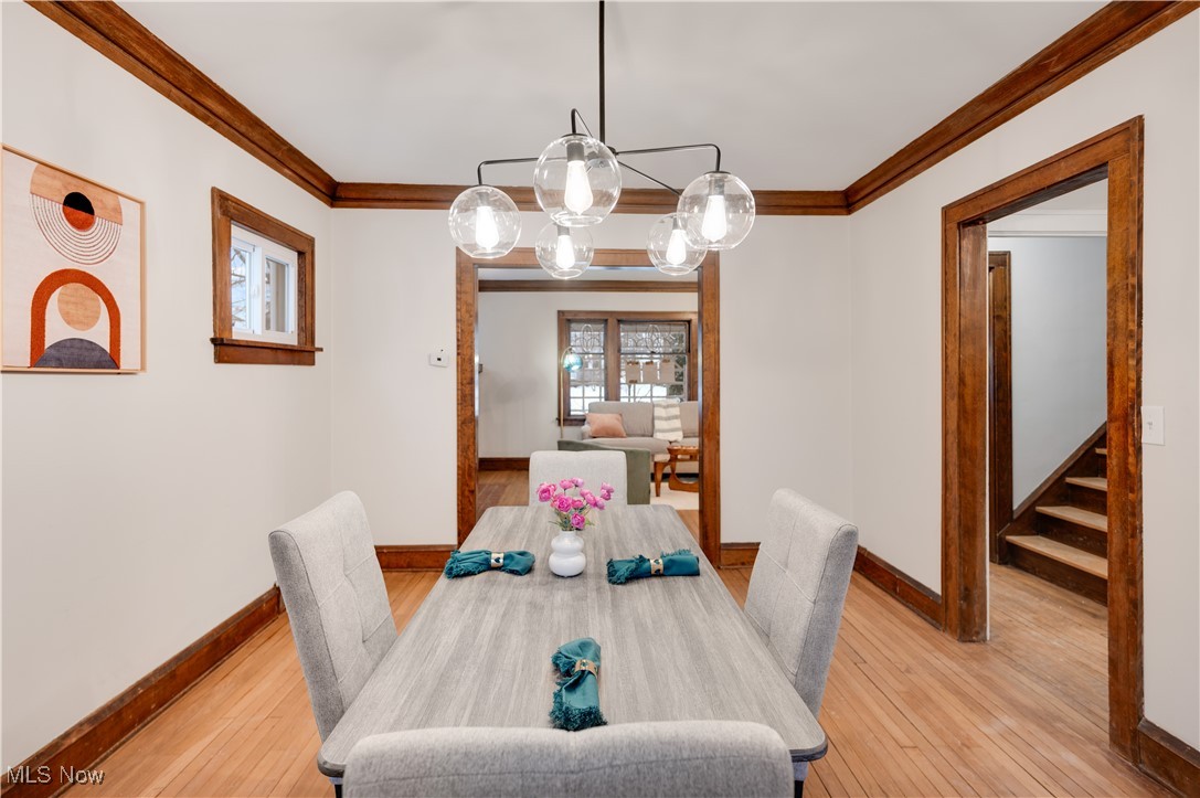 2016 Rossmoor Road Cleveland Heights, OH 44118 - Photo 15 of 46 Dining area with light wood-style flooring, ornamental molding, and a chandelier