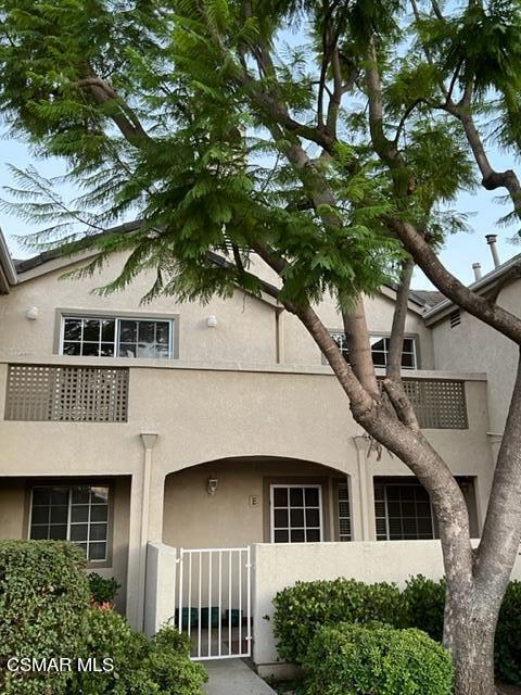 1225 Fitzgerald Road, Unit E Simi Valley, CA 93065 - Photo 2 of 30 a front view of a house with a tree