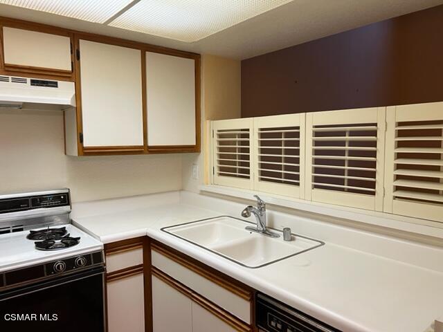 1225 Fitzgerald Road, Unit E Simi Valley, CA 93065 - Photo 6 of 30 a kitchen with a sink cabinets and appliances