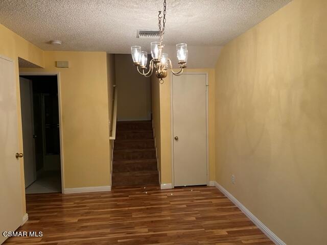1225 Fitzgerald Road, Unit E Simi Valley, CA 93065 - Photo 8 of 30 a view of a chandelier in an empty room
