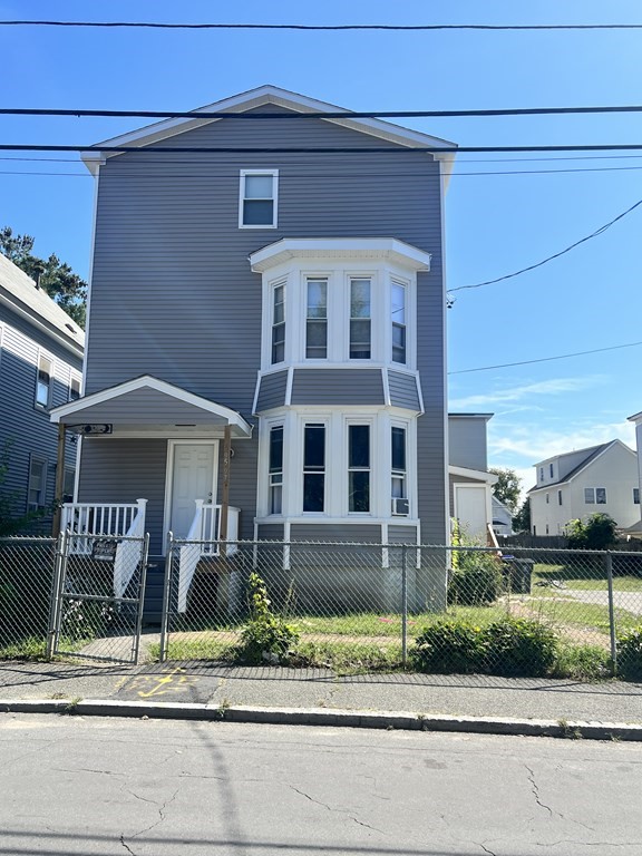 95-97 Tenney Street Methuen, MA 01844 - Photo 1 of 19 a front view of a house with a yard