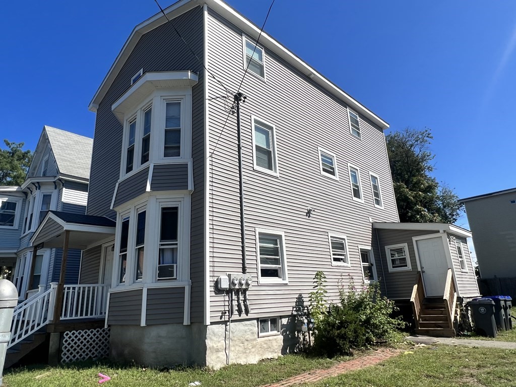 95-97 Tenney Street Methuen, MA 01844 - Photo 2 of 19 a front view of a house with a yard
