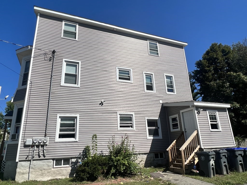 95-97 Tenney Street Methuen, MA 01844 - Photo 3 of 19 a front view of a house with a yard