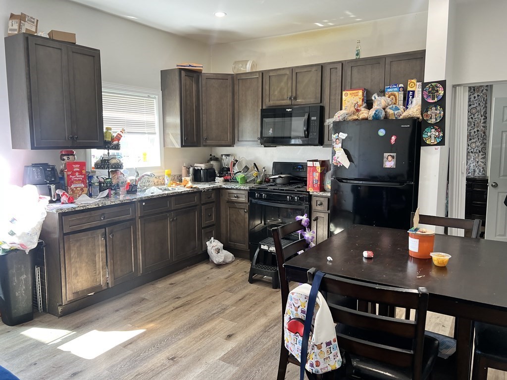 95-97 Tenney Street Methuen, MA 01844 - Photo 4 of 19 a kitchen with stainless steel appliances a stove refrigerator sink and microwave