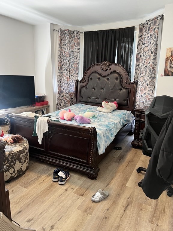 95-97 Tenney Street Methuen, MA 01844 - Photo 6 of 19 a bedroom with a bed and a chair