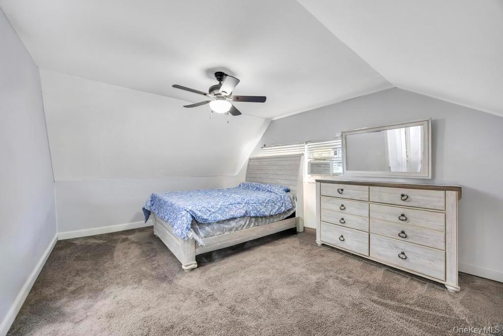 111 Blacksmith Road East Levittown, NY 11756 - Photo 12 of 14 Bedroom featuring lofted ceiling, light carpet, and a ceiling fan