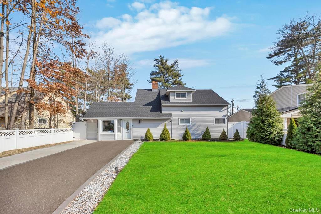 111 Blacksmith Road East Levittown, NY 11756 - Photo 13 of 14 View of front facade with a chimney, asphalt driveway, and roof with shingles