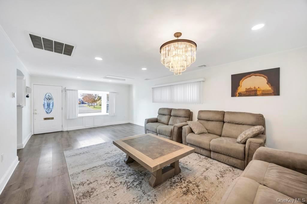 111 Blacksmith Road East Levittown, NY 11756 - Photo 4 of 14 Living room with recessed lighting, wood finished floors, and a chandelier