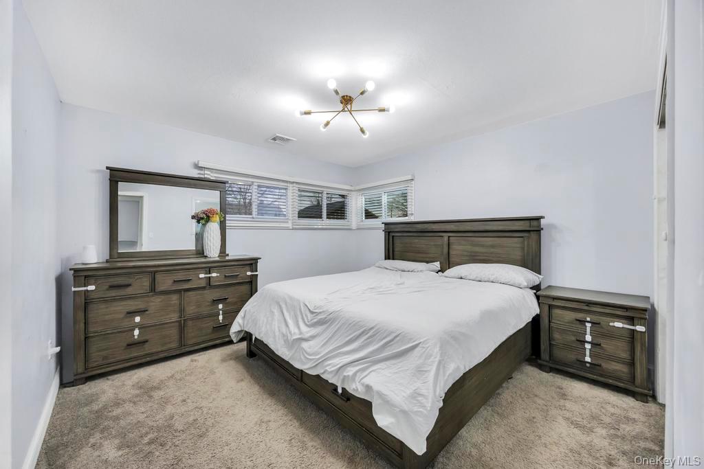 111 Blacksmith Road East Levittown, NY 11756 - Photo 7 of 14 Bedroom featuring light carpet and baseboards