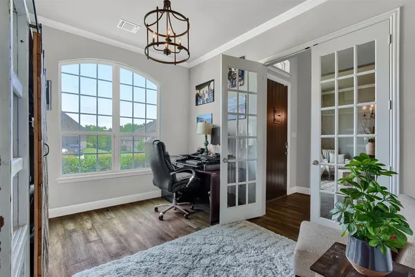 a view of a livingroom with workspace and a window