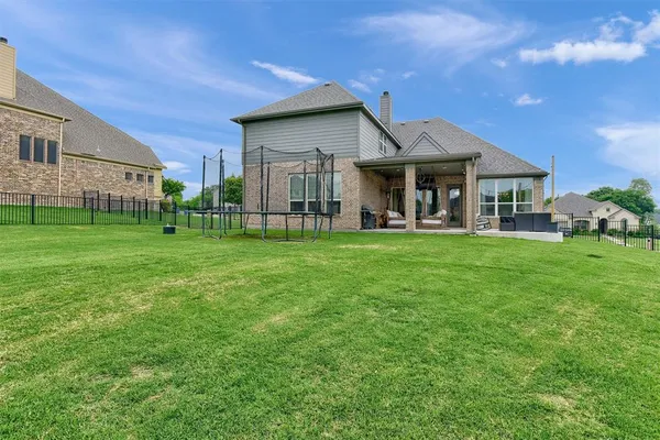 a front view of a house with a garden and patio